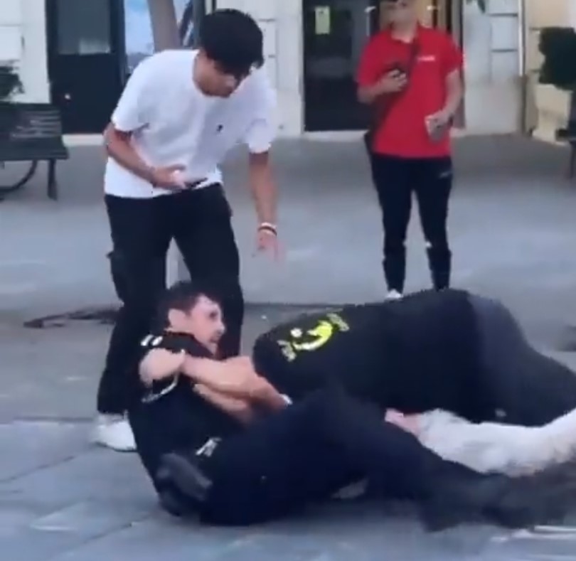 Un señor mayor ayuda a unos policías de la guardia urbana en otra caótica intervención