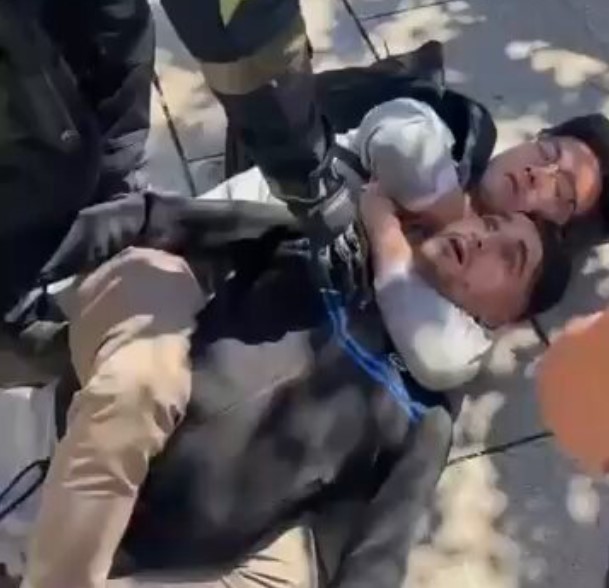 Un turista asiático realiza la técnica del ‘mataIeón’ para retener un ladrón (de esos que van en patinete) en Barcelona.